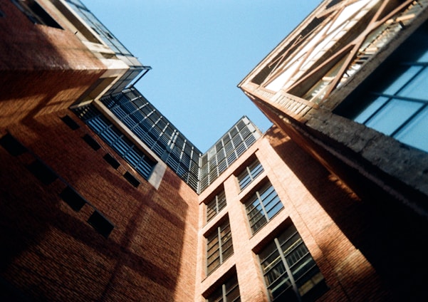 looking up at two tall buildings in a city