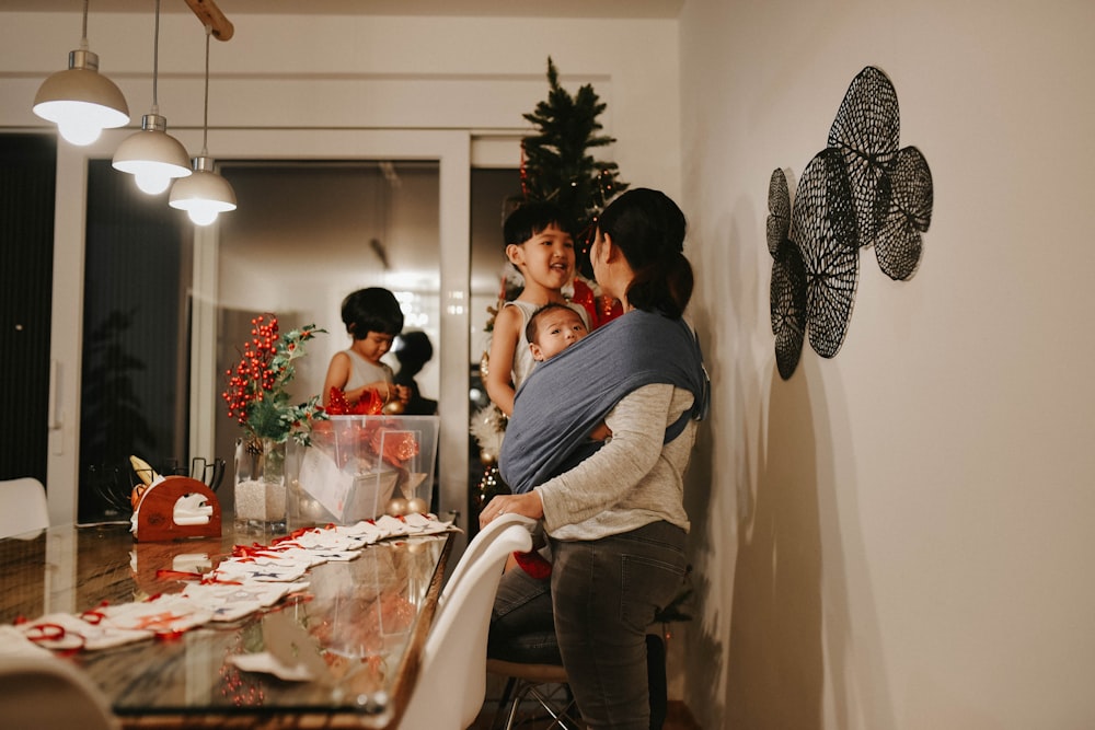 a group of people standing around a kitchen table