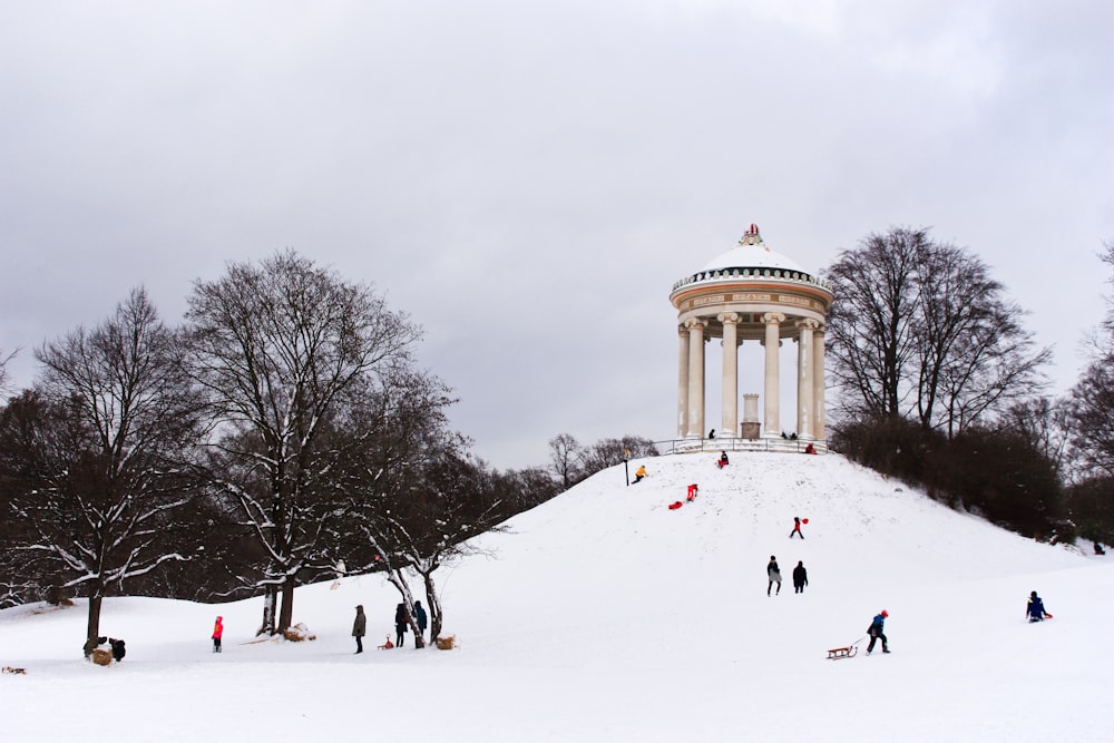 a group of people walking up a snow covered hill