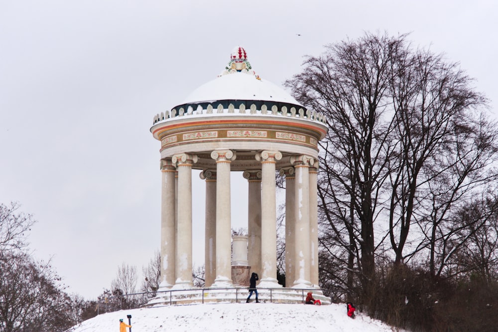 a large white monument sitting on top of a snow covered hill
