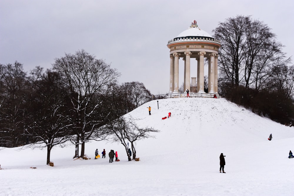 a group of people standing on top of a snow covered slope