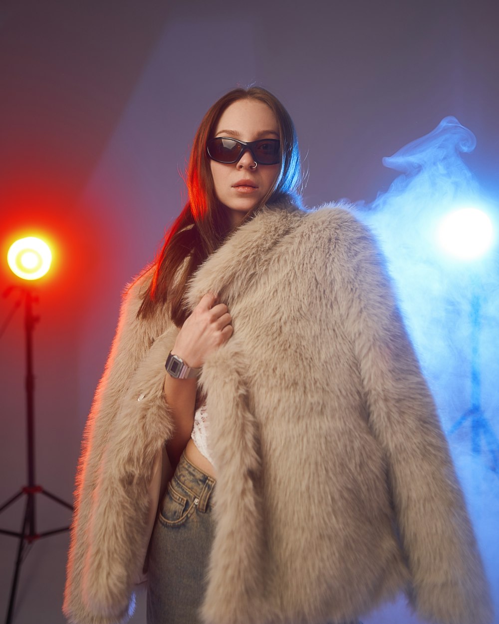 a woman wearing sunglasses and a fur coat