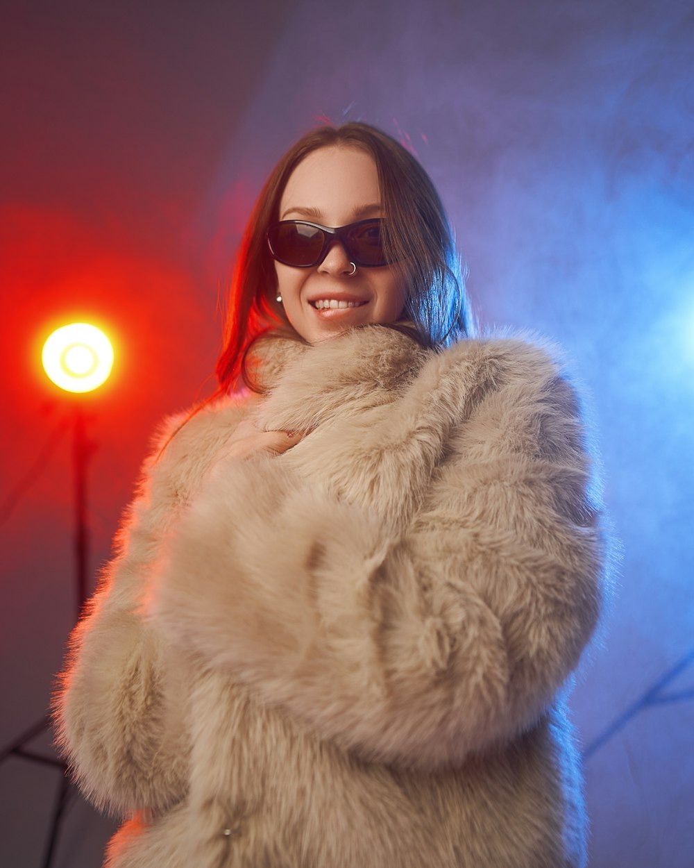 a woman wearing sunglasses and a fur coat