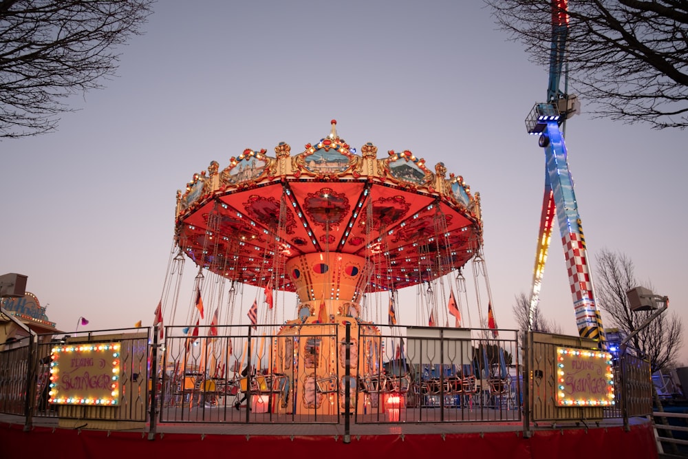 a merry go round at a carnival at dusk