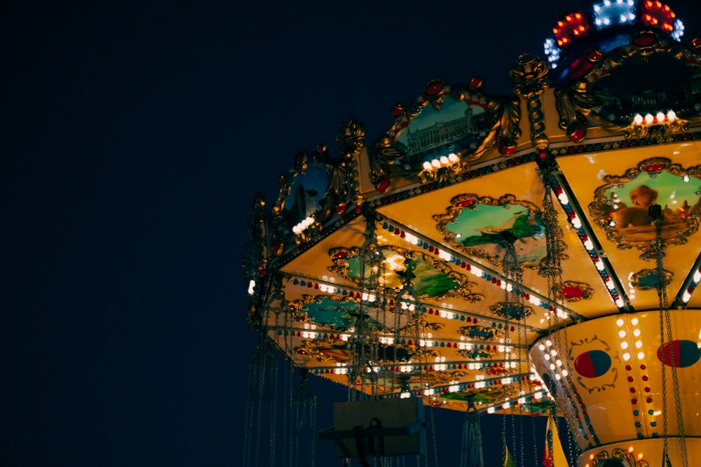 a brightly lit merry go round at night