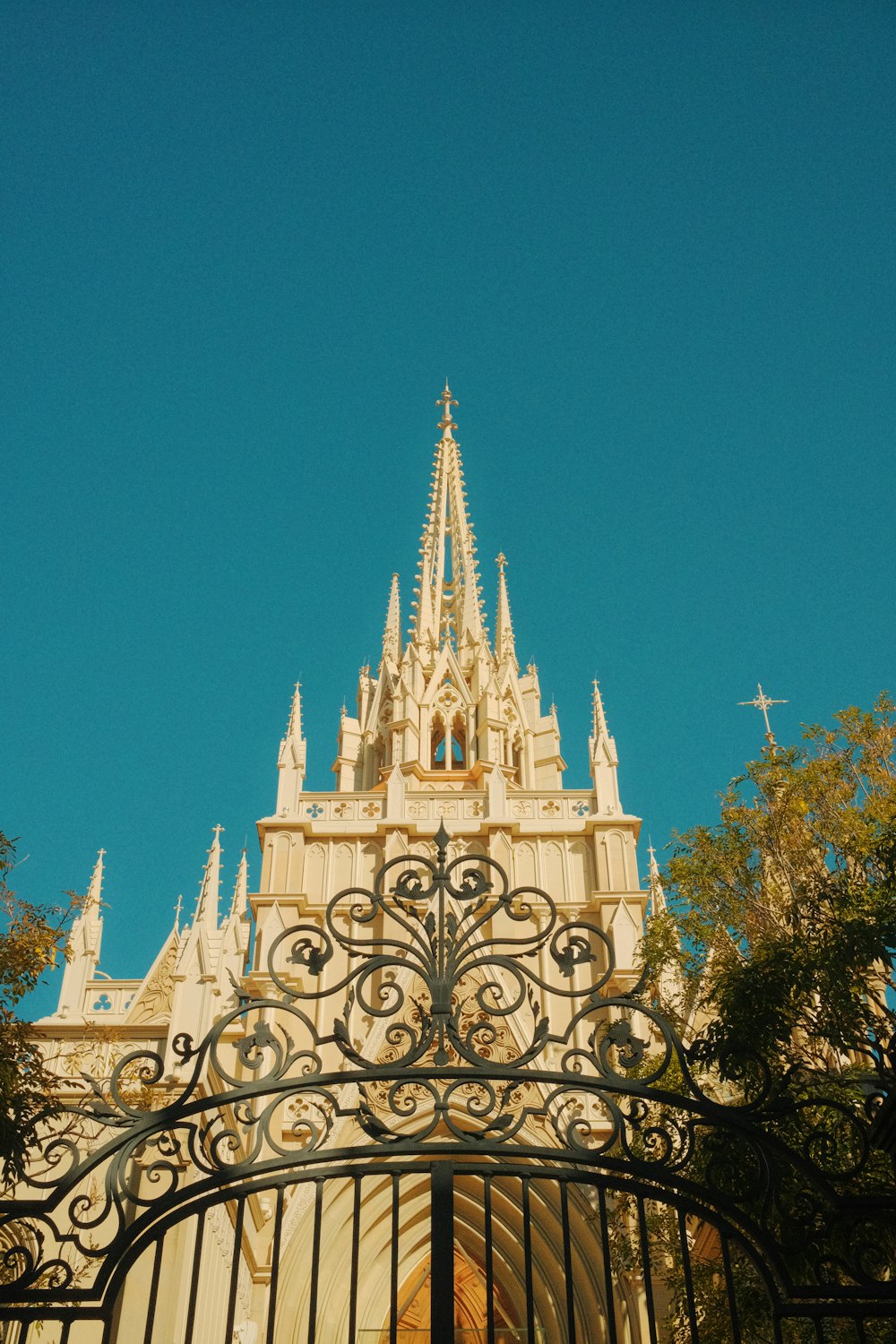 a tall building with a gate and a clock on it