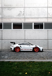 a white sports car parked in front of a building