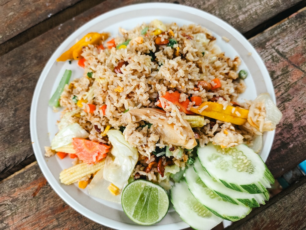 a white plate topped with rice and veggies