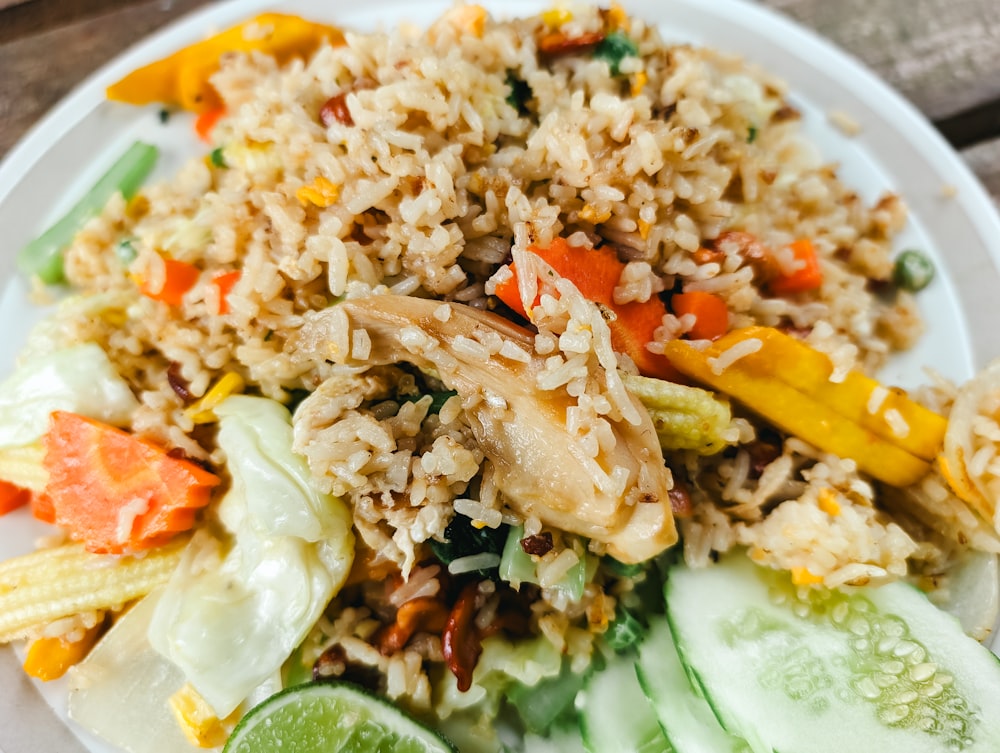a white plate topped with rice and veggies