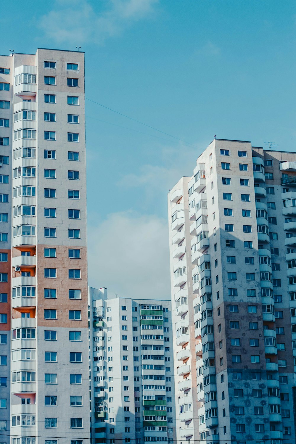 a couple of tall buildings sitting next to each other