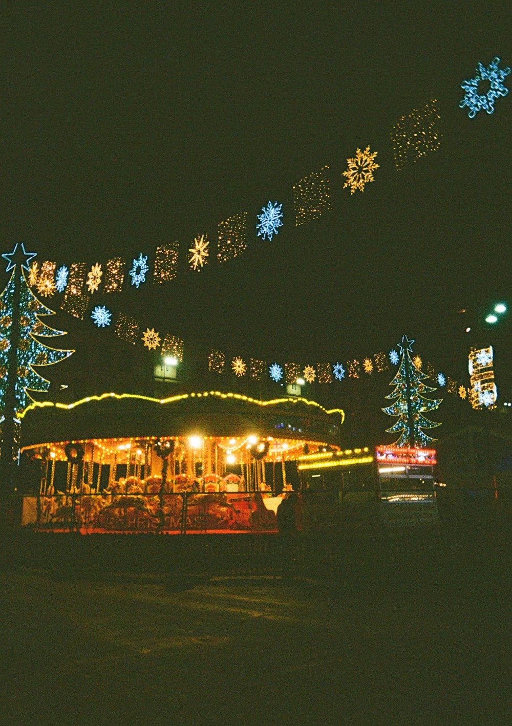 a carousel is lit up with christmas lights