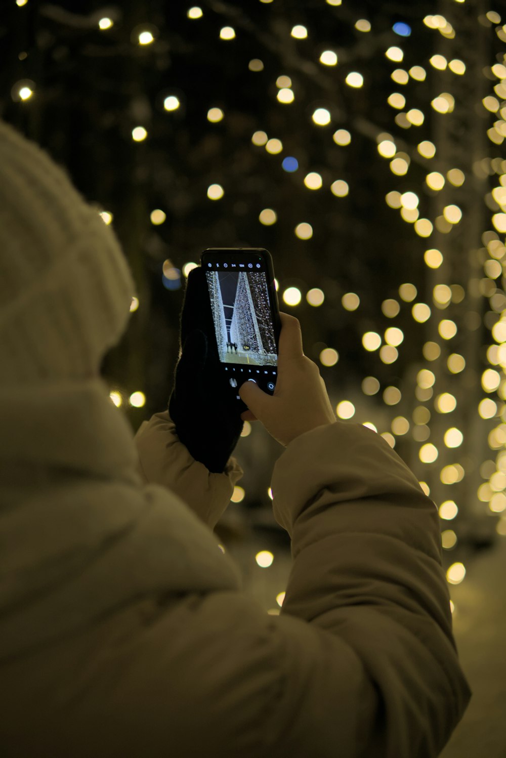 a person taking a picture of a tree with a cell phone