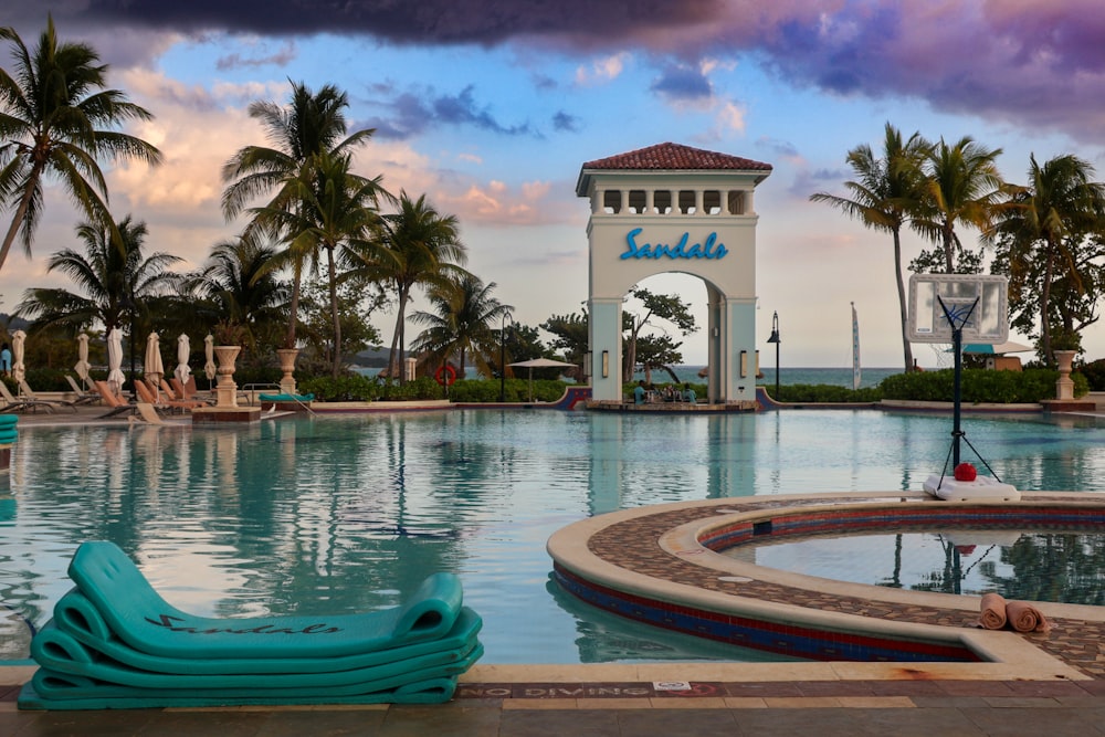 a large swimming pool with a clock tower in the background