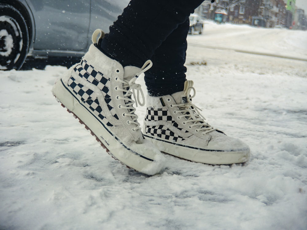 a person standing in the snow with their shoes on
