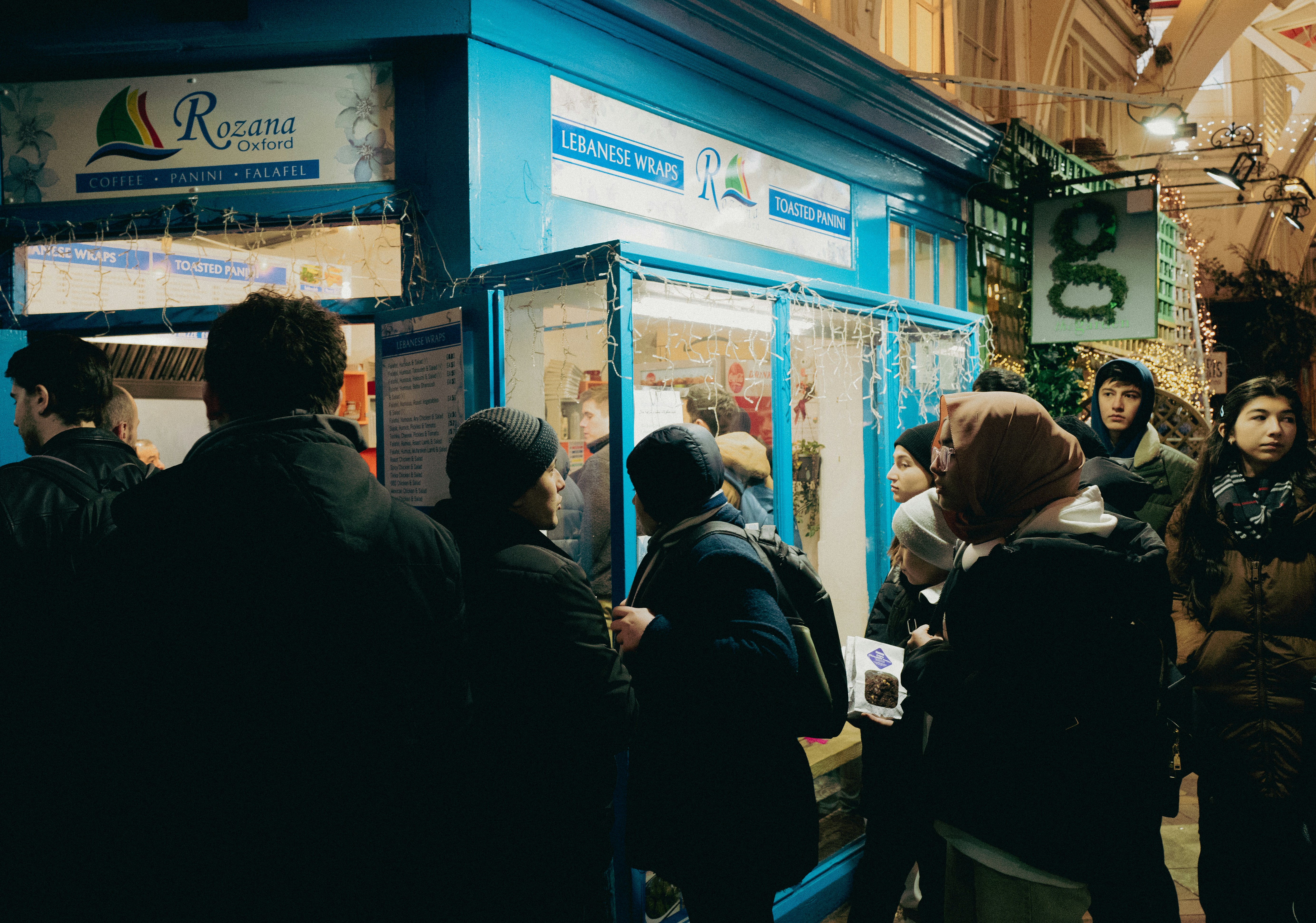 a group of people standing in front of a store
