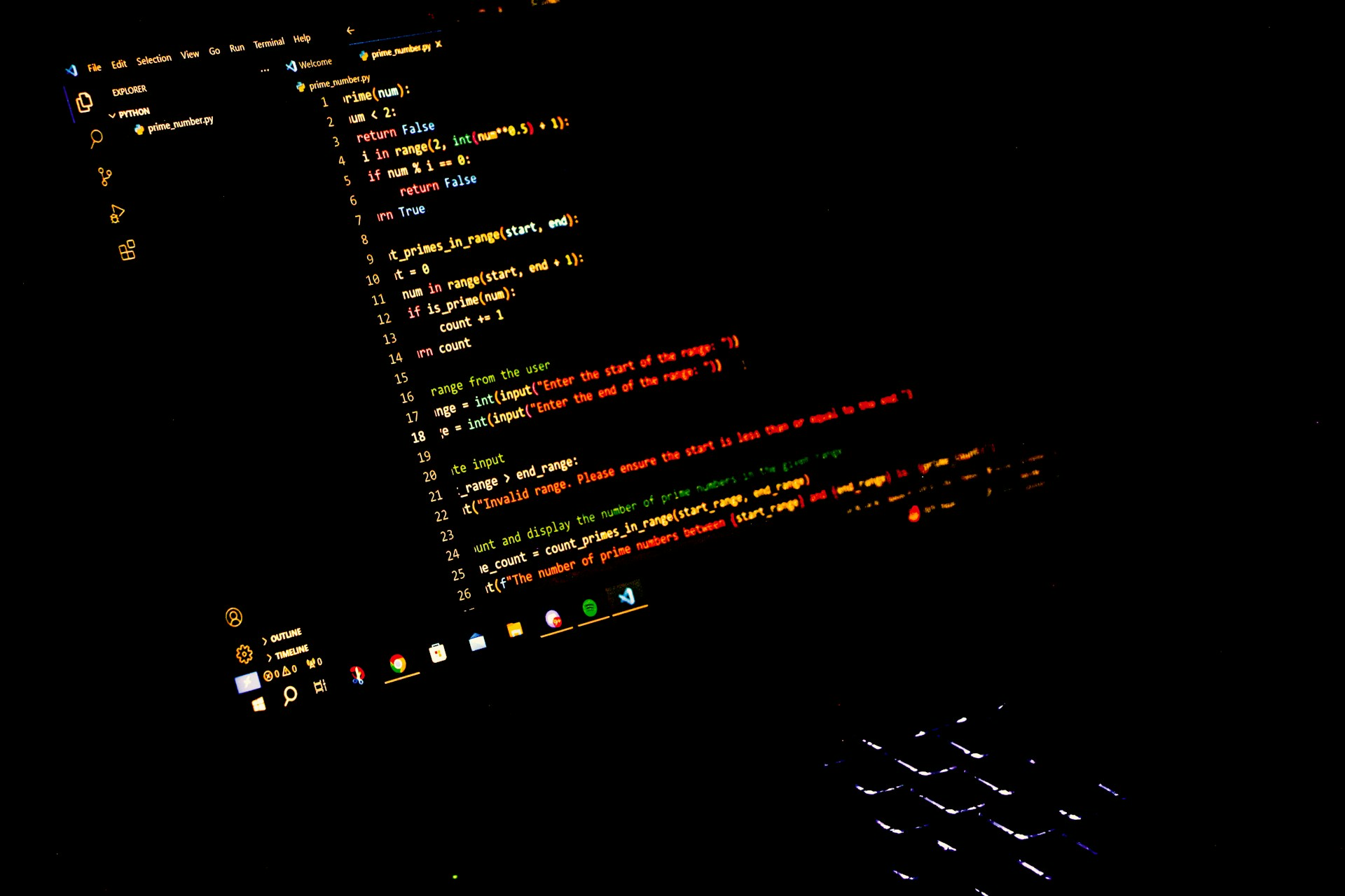 a computer screen with a keyboard in the dark
