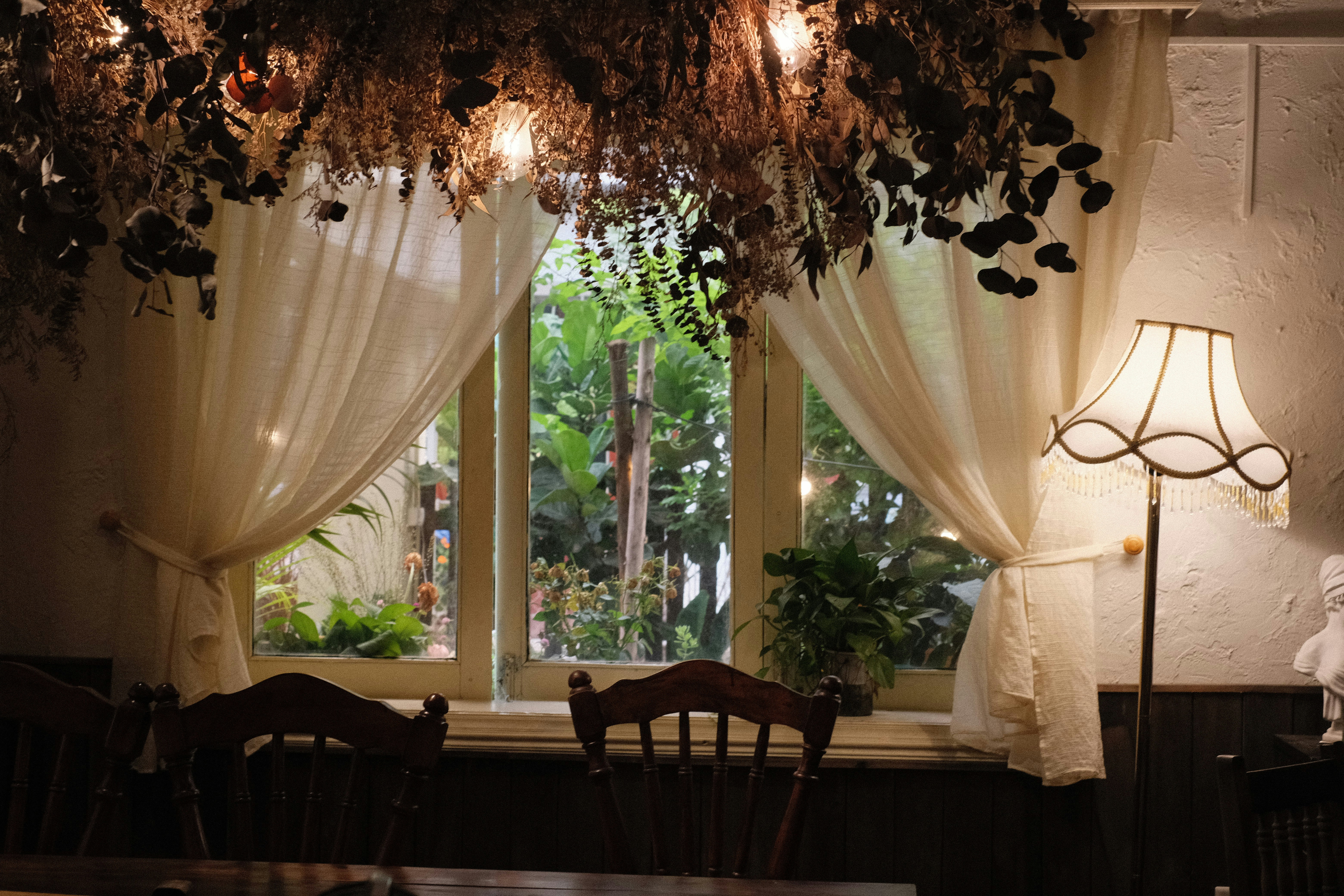 a dining room with a table, chairs and a window