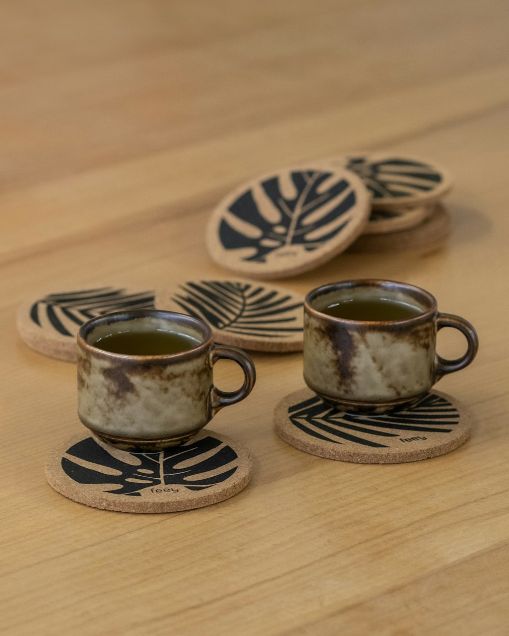 a couple of cups sitting on top of a wooden table