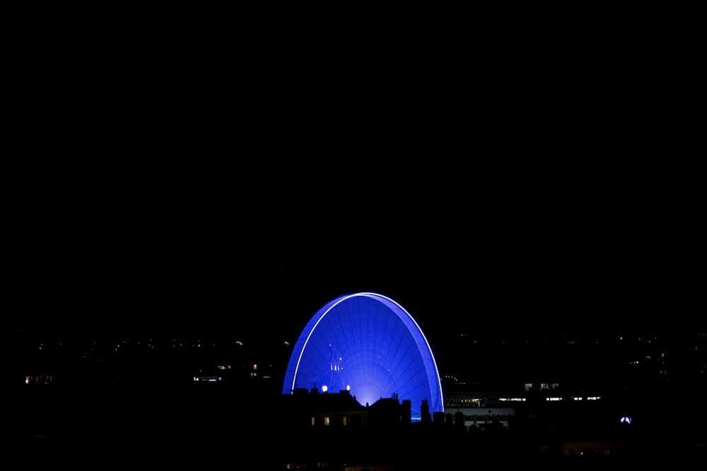 a large blue object in the middle of a dark sky