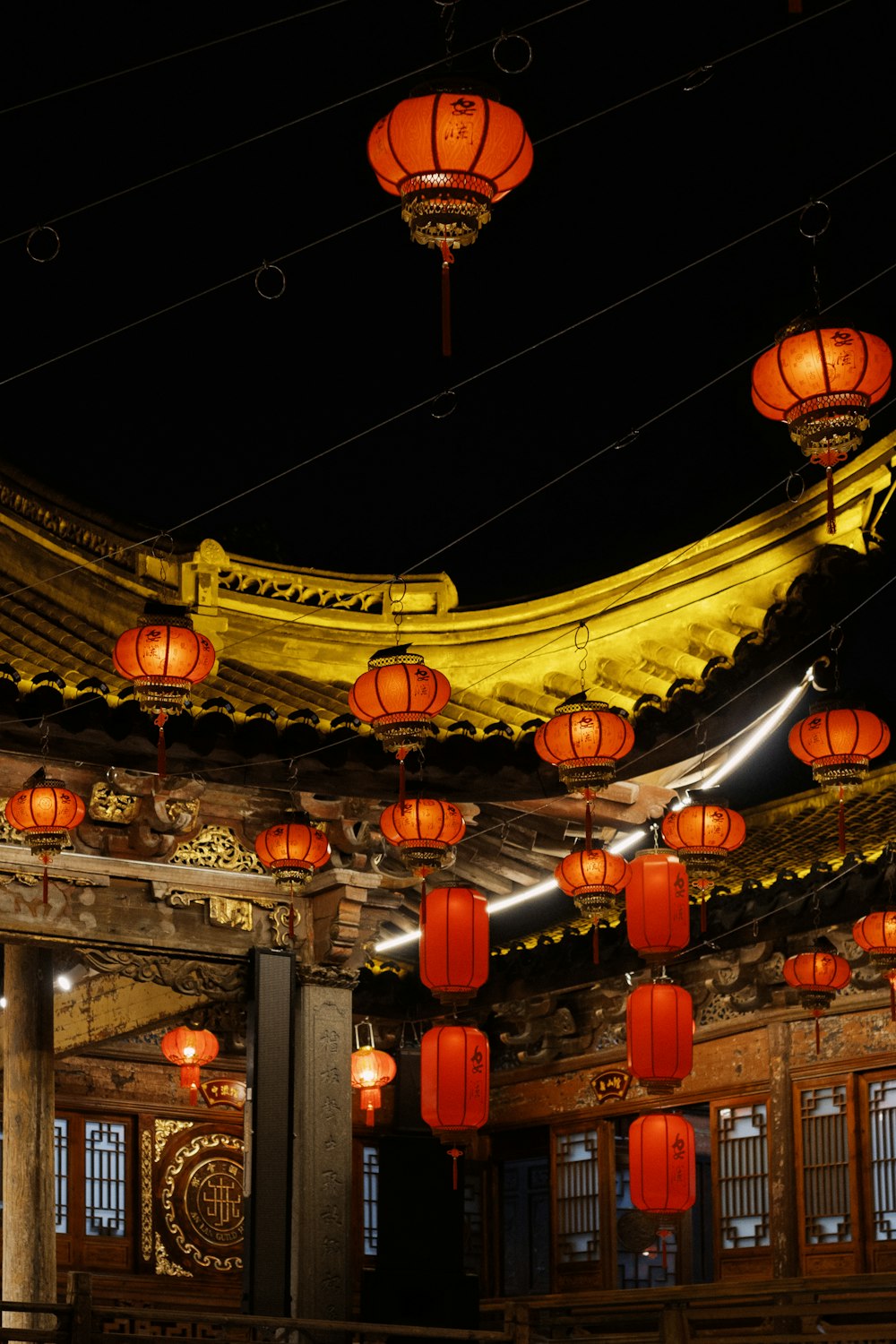 a group of red lanterns hanging from the ceiling of a building