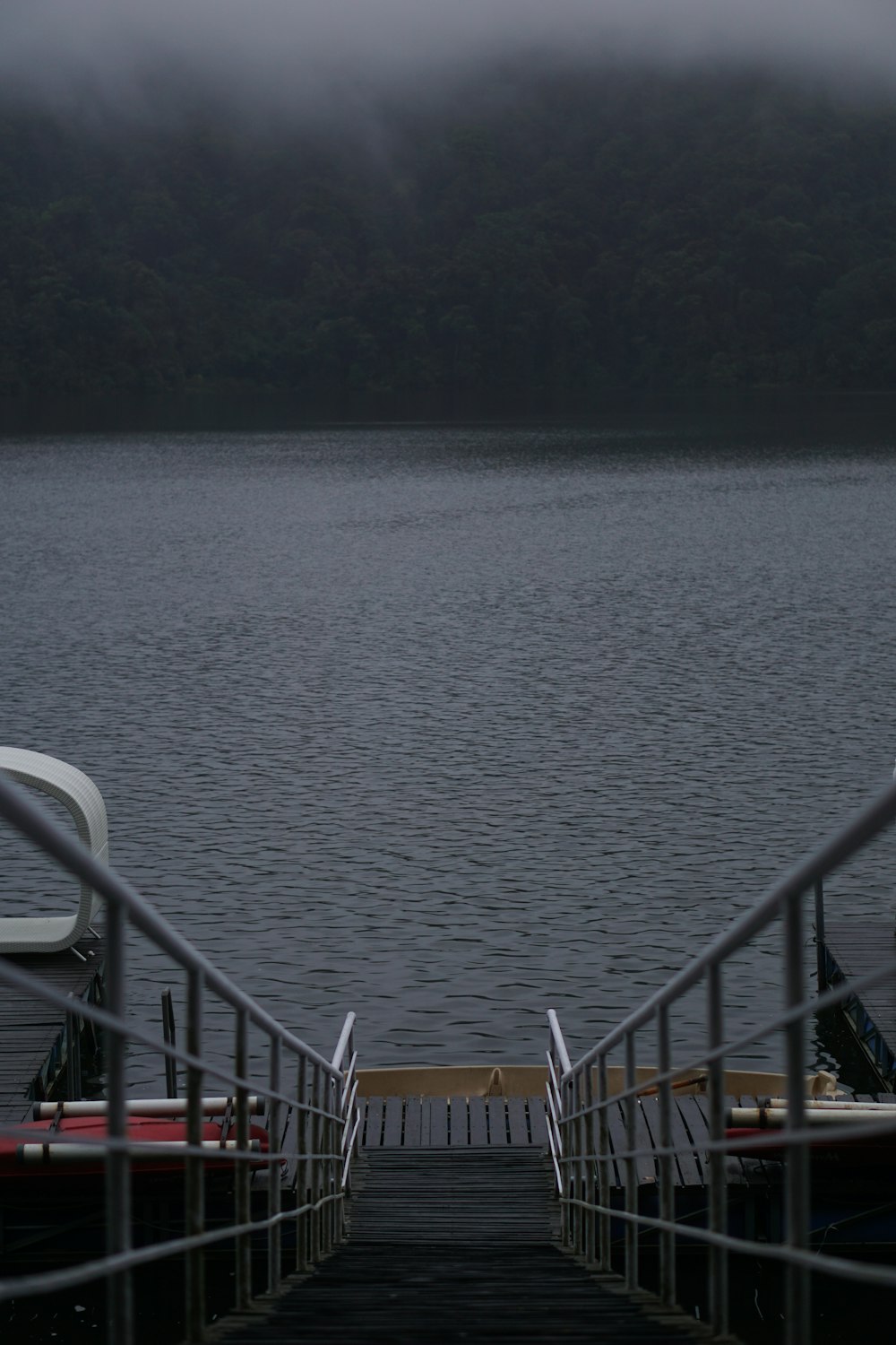 a dock on a lake with a boat tied to it