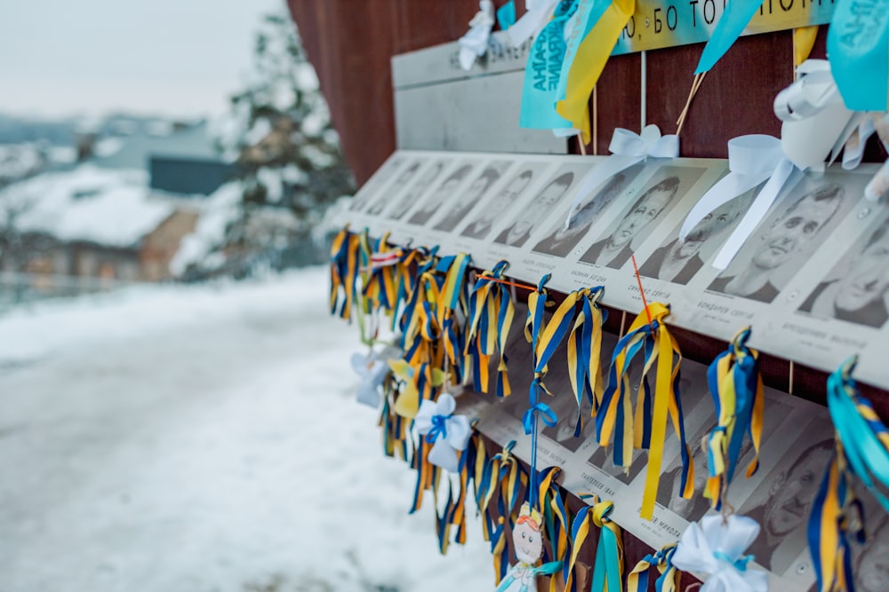 a bulletin board with ribbons hanging from it