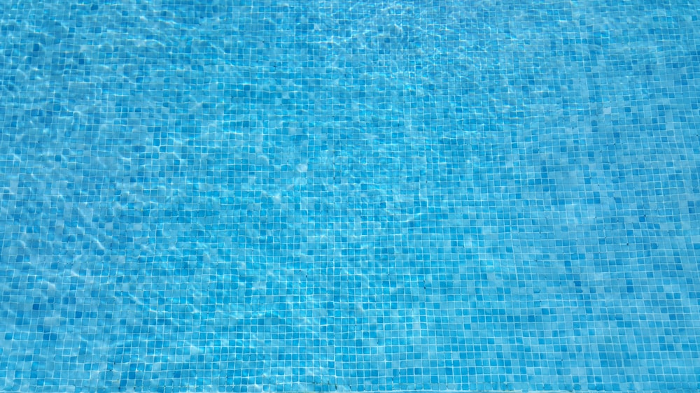 a blue swimming pool with blue tiles