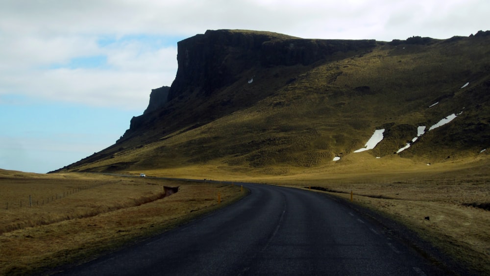 a long road with a mountain in the background