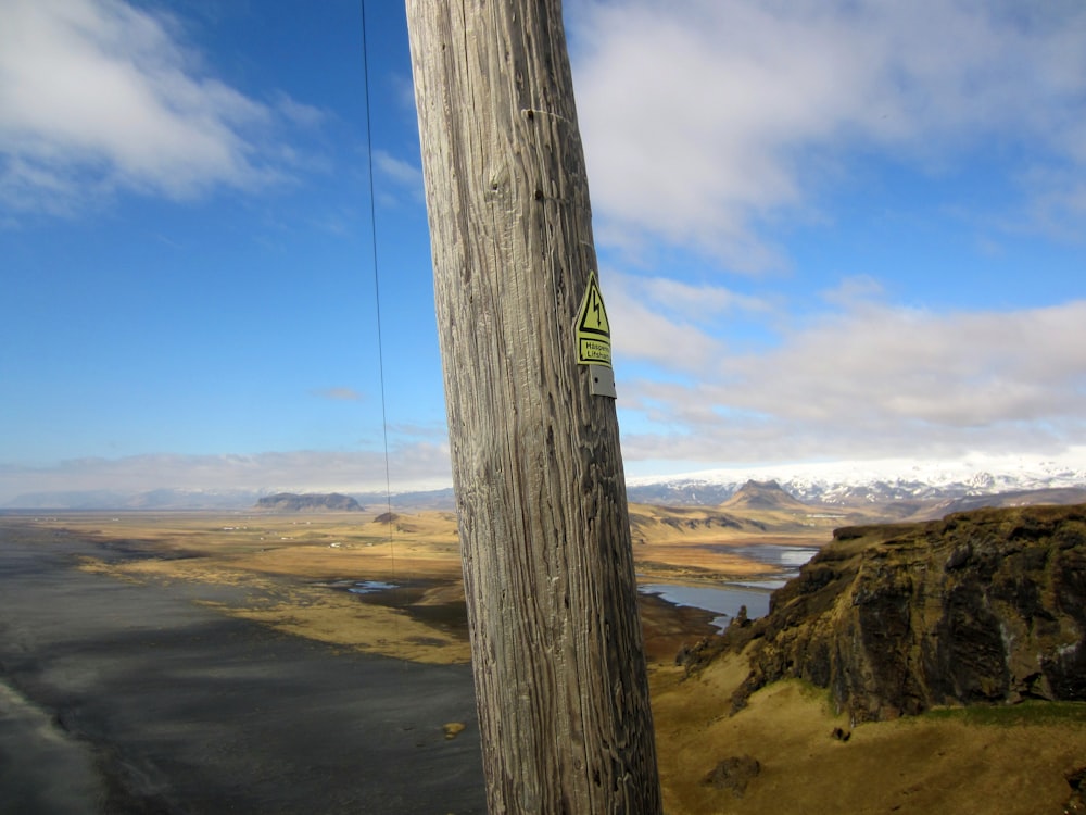 a wooden pole with a sign on it
