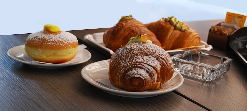 a table topped with pastries and pastries covered in powdered sugar