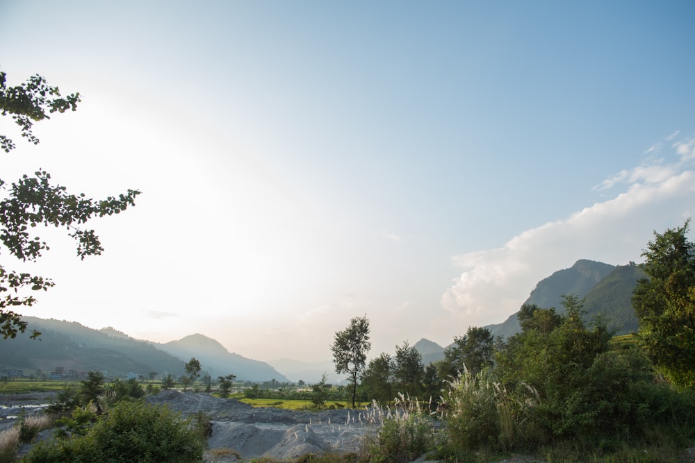 the sun shines brightly over a mountain range