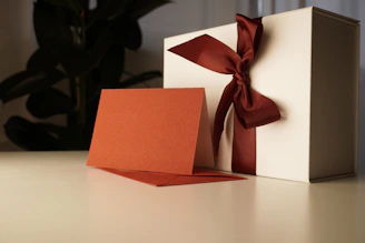 a white box with a red bow on top of it