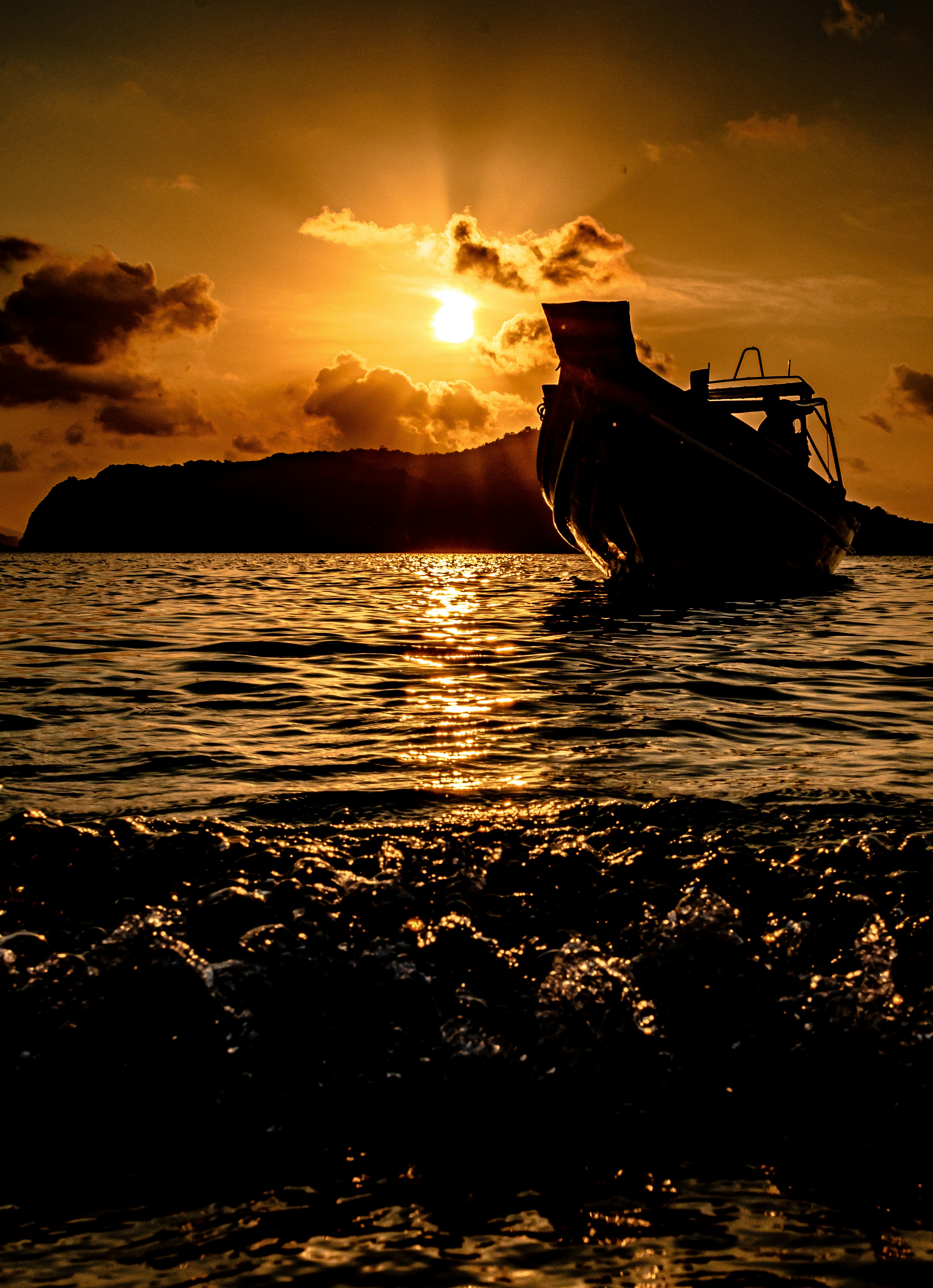 a boat is in the water at sunset