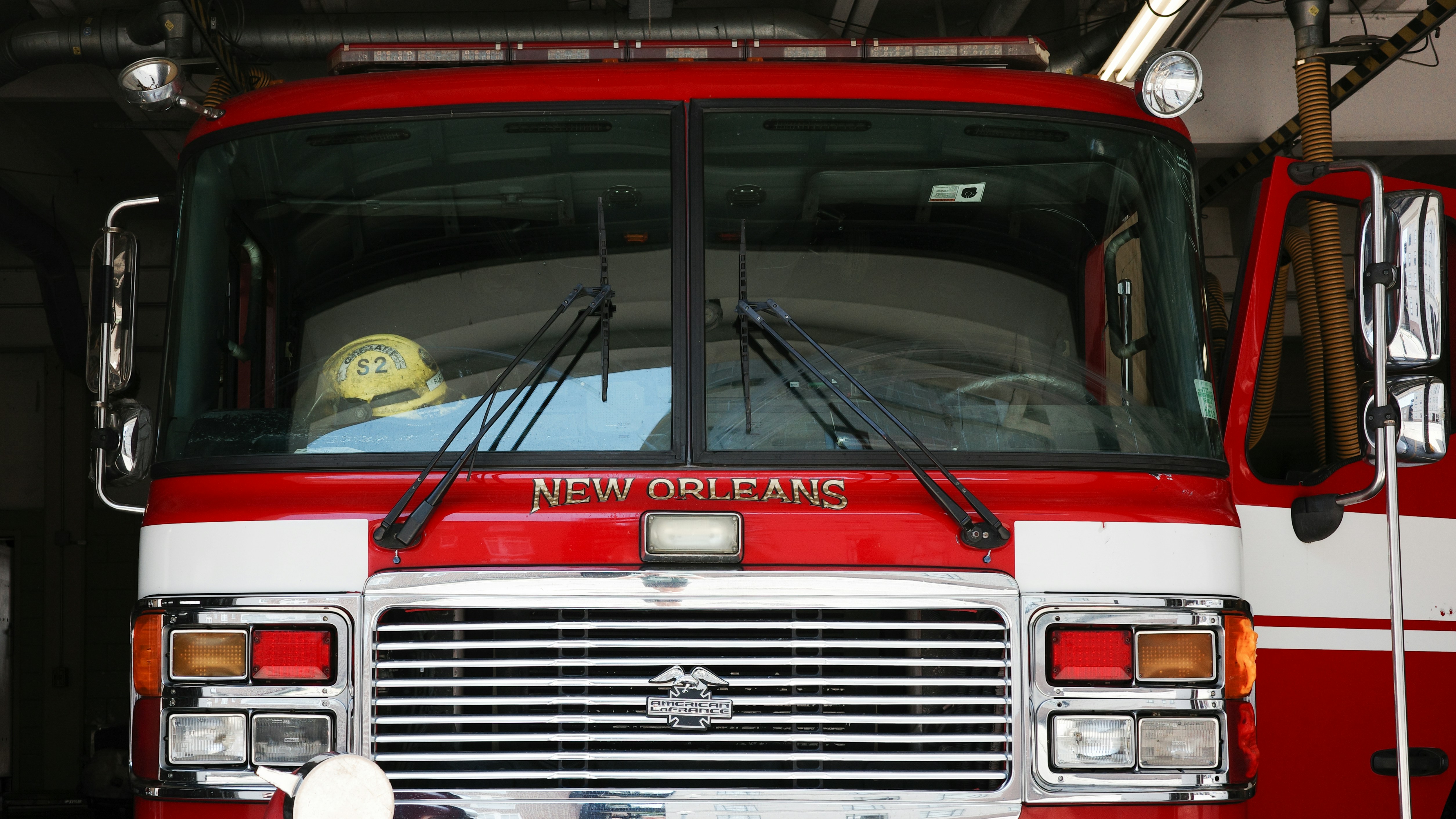 a red and white fire truck parked in a garage