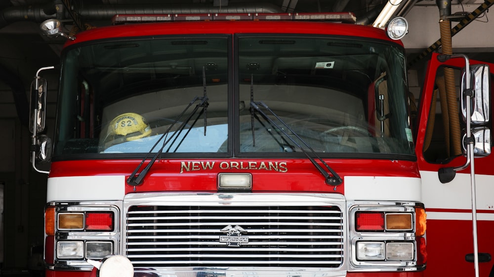 a red and white fire truck parked in a garage