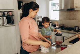a woman and a child are in the kitchen