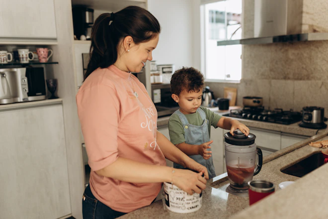 a woman and a child are in the kitchen