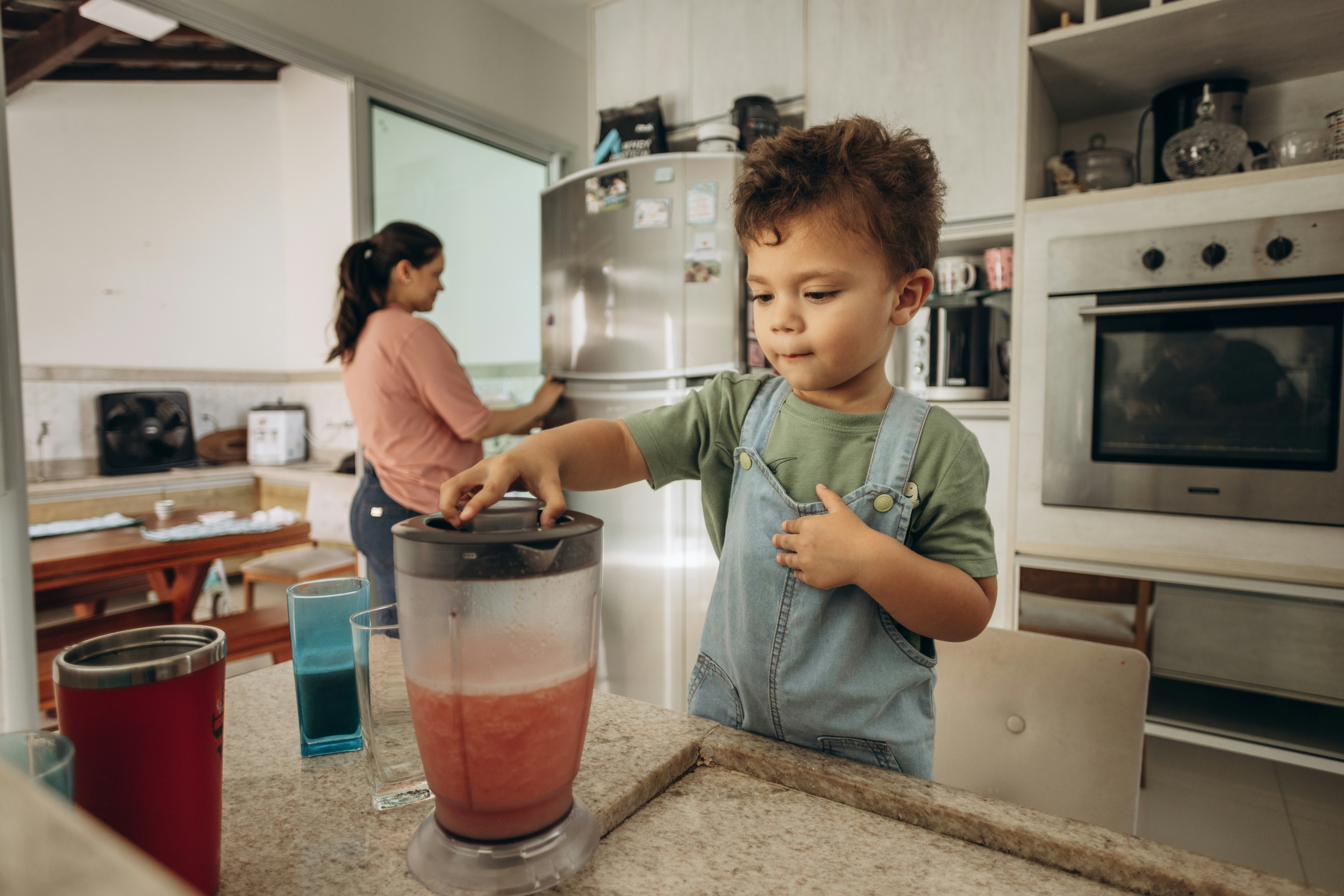 high performance blender smart kitchen - a young boy is making a smoothie in a blender