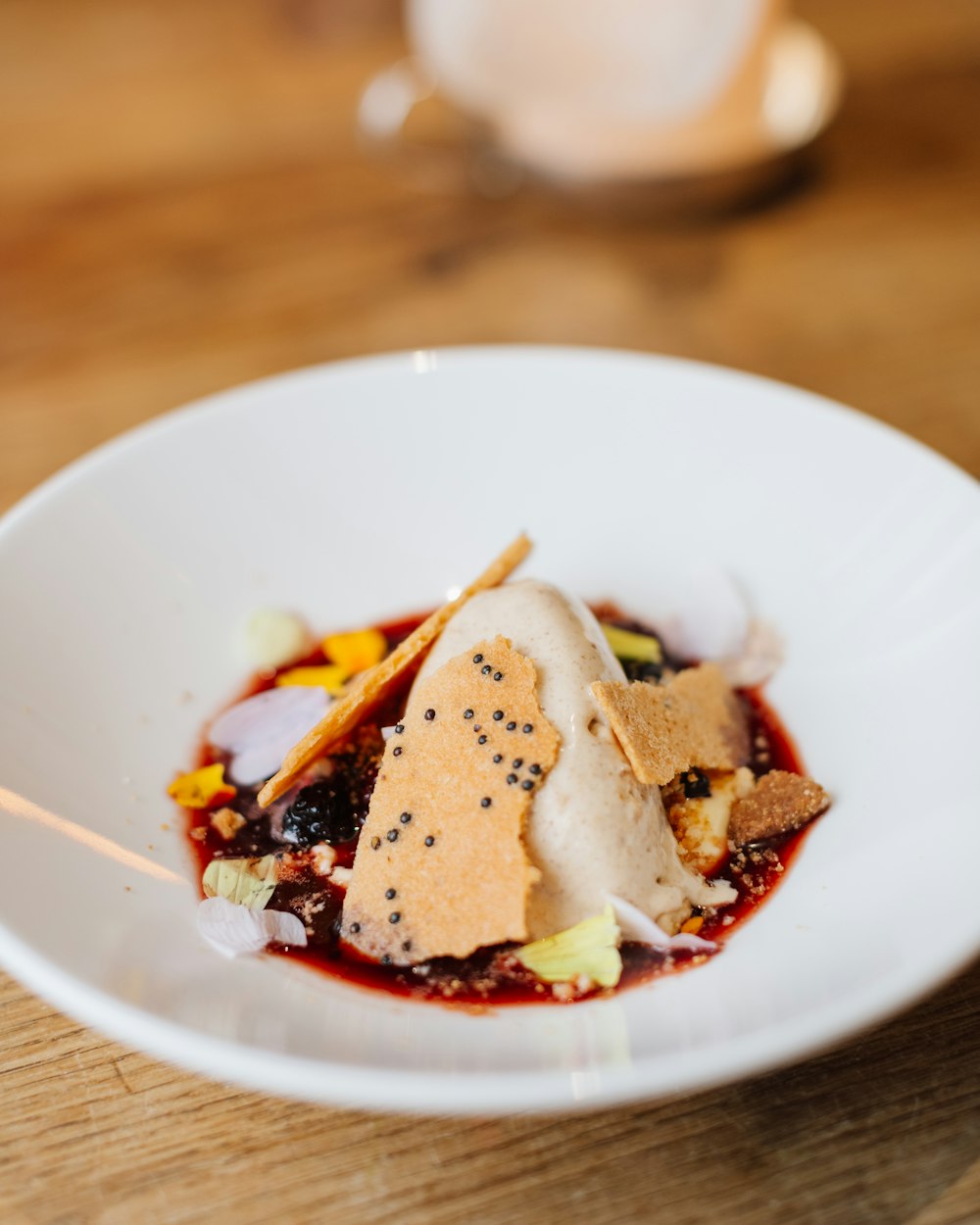 a white bowl filled with food on top of a wooden table