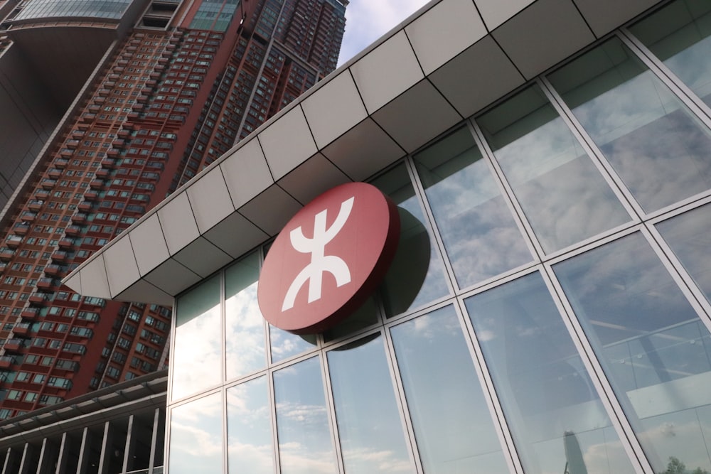 a red and white sign hanging from the side of a building