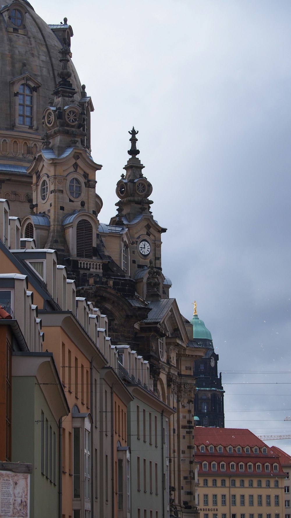 a row of buildings with a clock tower in the background