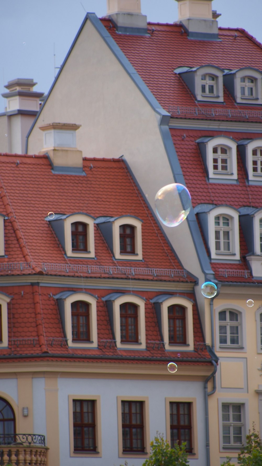 a house with a red roof and a bubble in the air