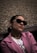 a woman wearing sunglasses and a pink jacket