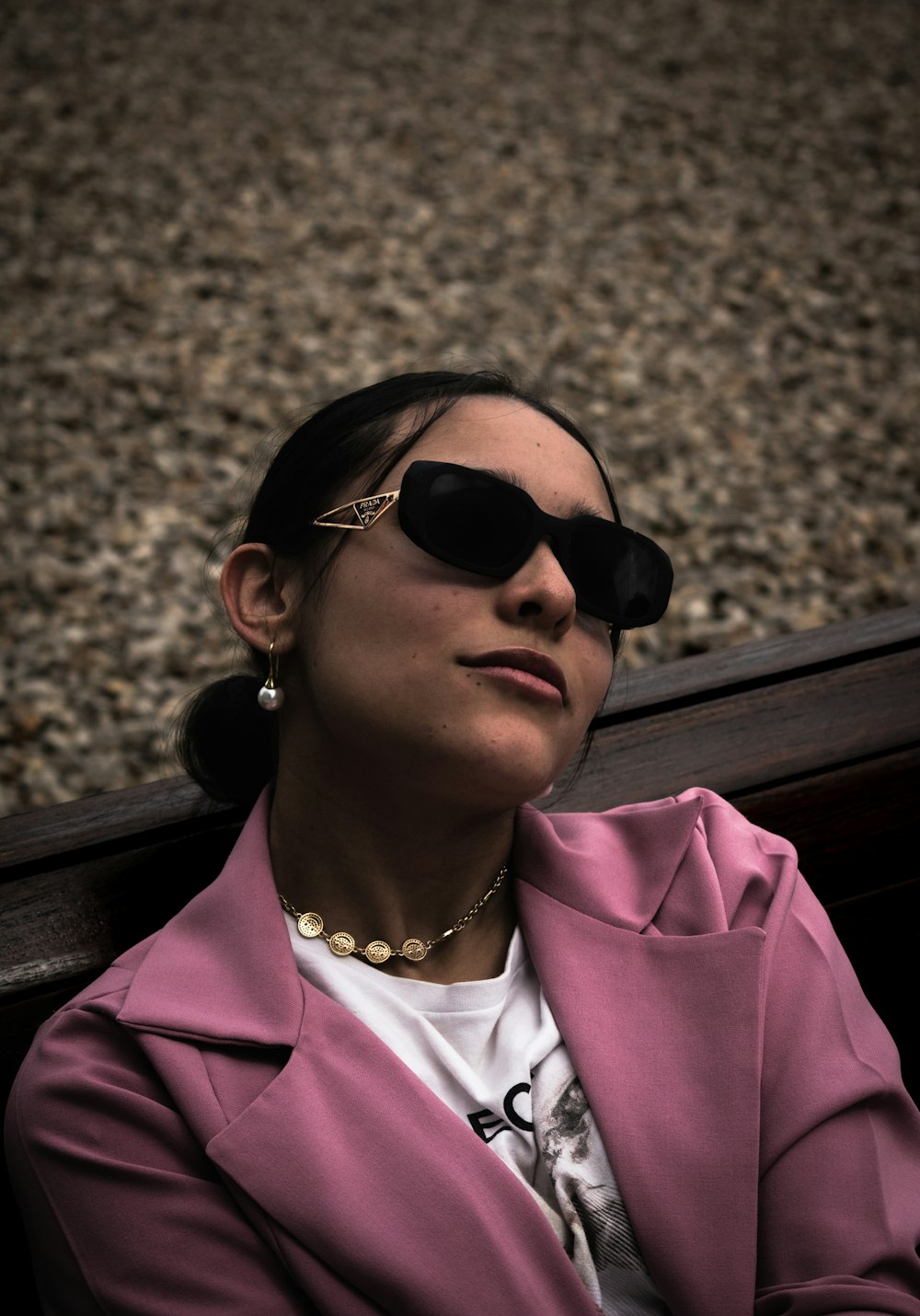 a woman wearing sunglasses and a pink jacket