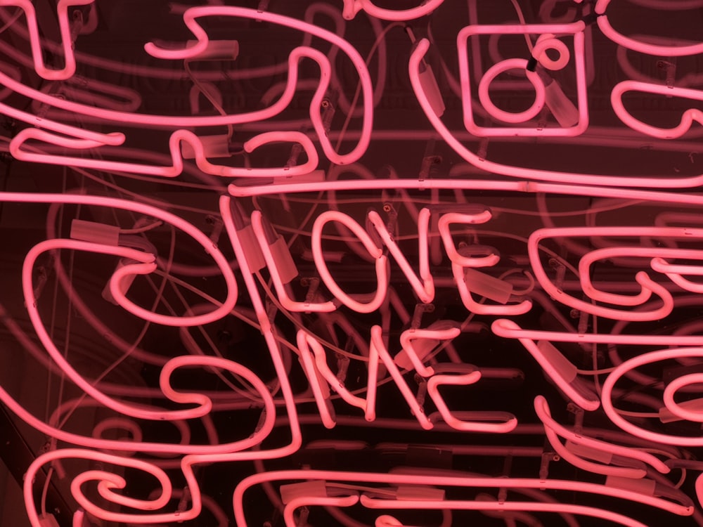 a neon sign that says love me
