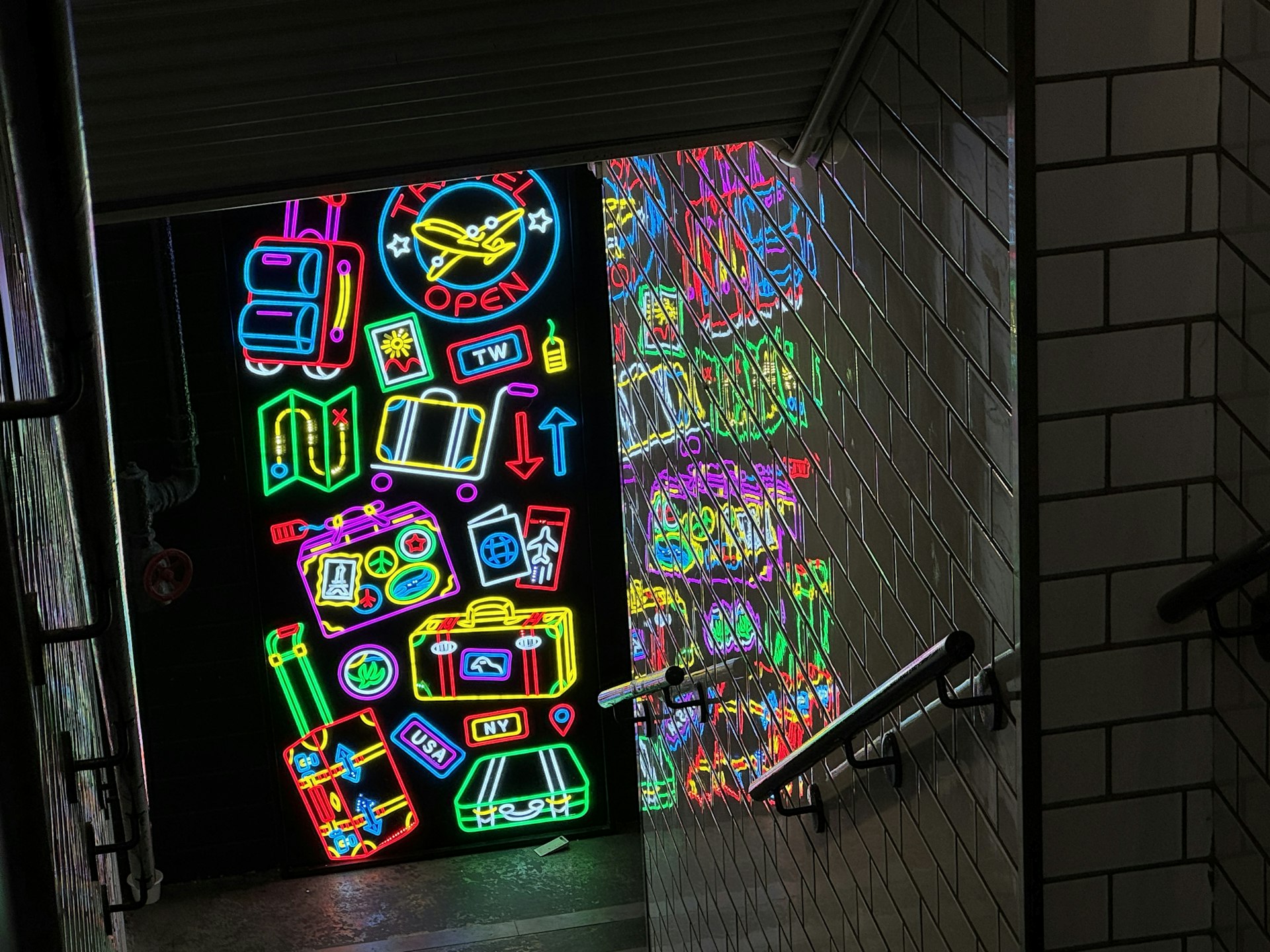 a wall of neon signs in a dark room