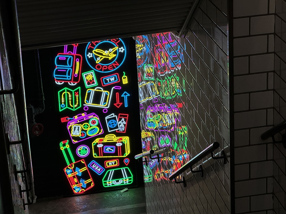 a wall of neon signs in a dark room