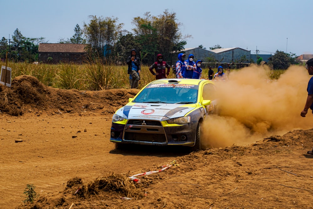 a car driving on a dirt road with dust coming out of it