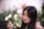a woman with long black hair is looking away from the camera