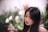 a woman with long black hair is looking away from the camera